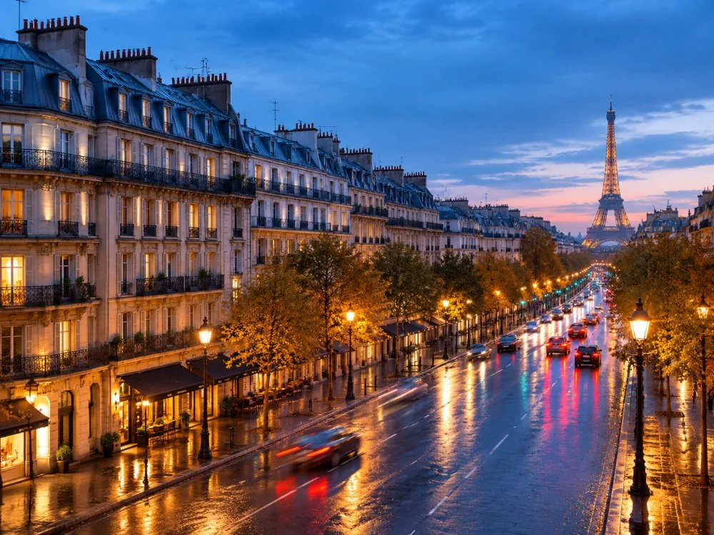 Boulevard Haussmann in the evening, lit streetlamps and Haussmannian buildings